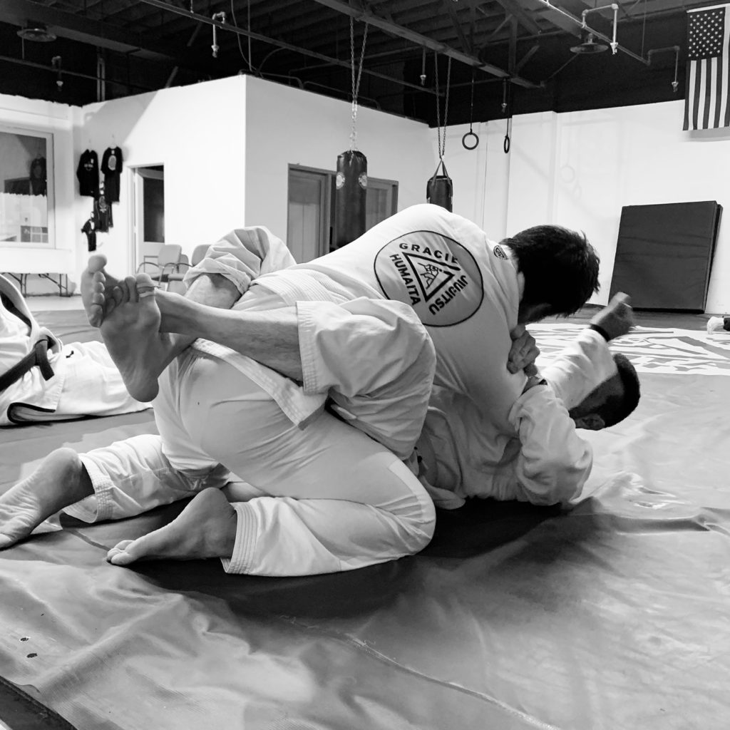 Two Adults In Kansas City On The Ground Grappling At Gracie Humaita Kansas City Jiu Jitsu